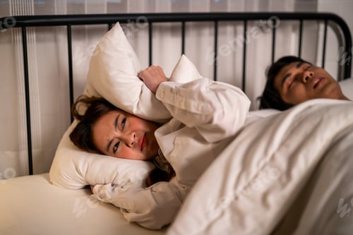 Preview: Asian woman feel frustrated from husband snoring while sleep at night.