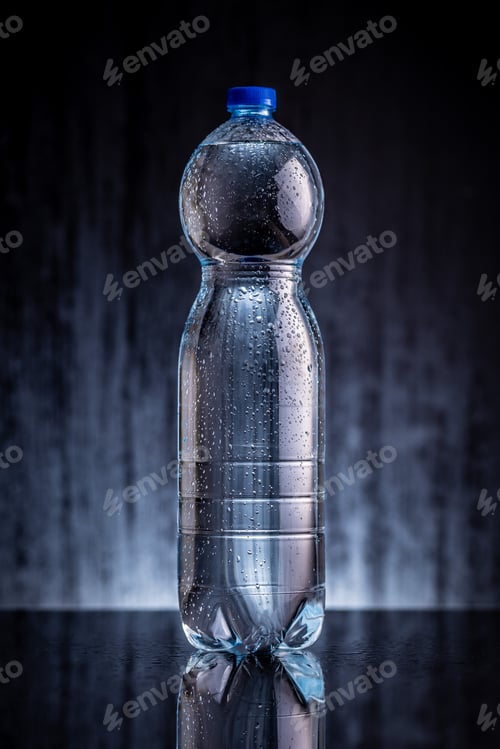 Preview: Plastic cold bottle of water with water drops.
