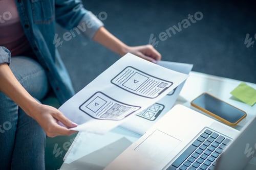 Preview: Close up of sketches in female hands