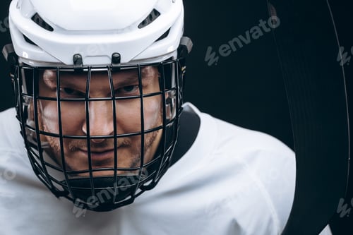 Preview: Portrait of sportsman in hockey uniform over black background