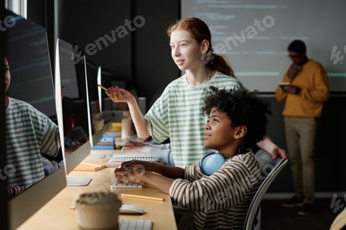 Preview: Girl Helping Classmate During IT Lesson