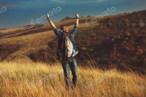 Preview: Young hiker enjoys a sunny day on the mountain