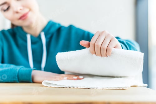 Preview: close-up view of woman holding clean white towel