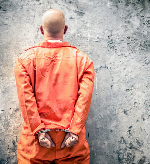Preview: Handcuffed prisoner waiting for death penalty with typical orange clothes