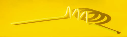 Preview: One yellow tube for drinks on a bright monochrome background. Banner