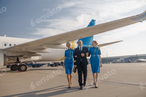 Preview: Pilot and Flight Attendants Walking on the Tarmac
