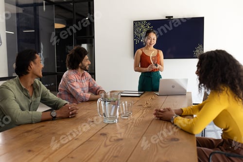 Preview: In modern office, business team collaborating and discussing project, smiling together