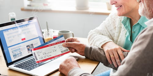Preview: Senior Adult Holding Ticket Laptop Concept