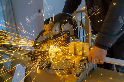 Preview: Metal sawing, worker man. Sparks while grinding iron