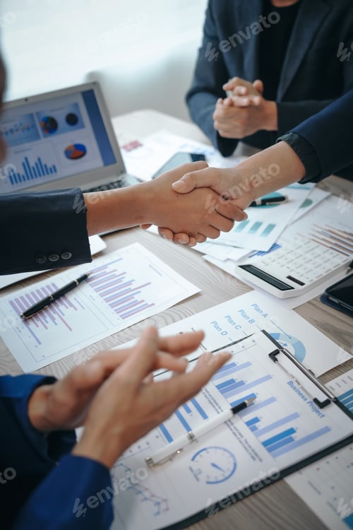 Preview: business team meeting, success is celebrated with handshake. Hands close up, dressed in formal suit