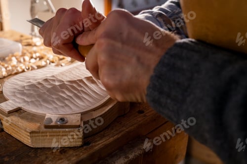 Preview: Luthier carving violin top plate with gouge and mallet