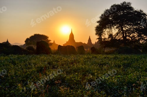 Preview: Sunset over distant stupa of temple in Bagan, Myanmar.