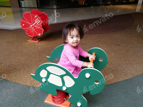 Preview: Baby toddler playing bouncy ride at the playground