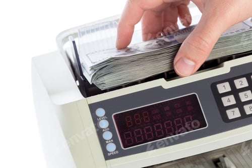 Preview: Counting cash with a money counting machine in a home office setup in the daytime