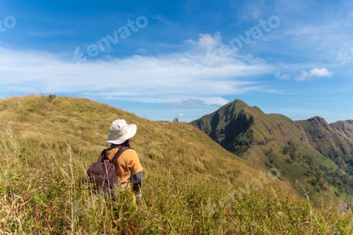 Preview: happy hiking woman stand on top mountain at Khao Chang Phuak, Thongphaphoom National Park, Thailand.