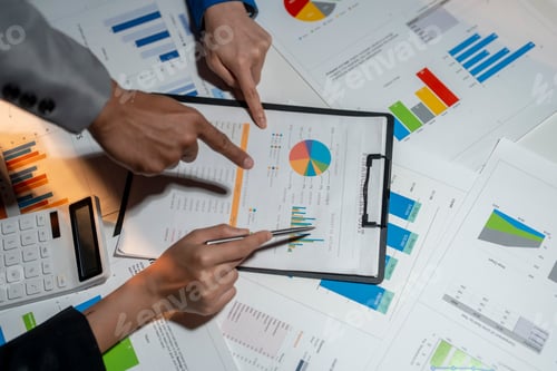 Preview: Two people are looking at a chart with a pie chart on it