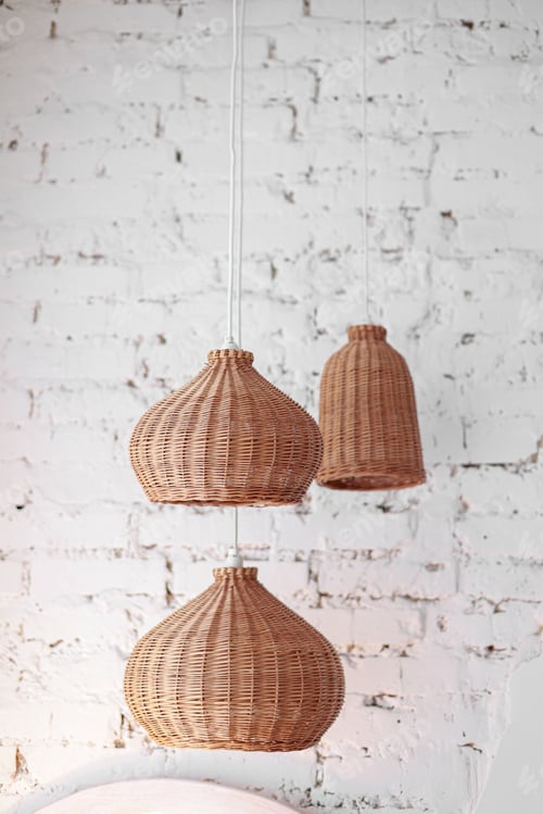 Preview: three rattan chandeliers different forms on white brick wall background. Straw lampshade in cozy