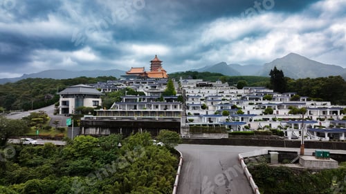 Preview: Aerial view of a serene cemetery in Taiwan surrounded by lush mountains and a temple
