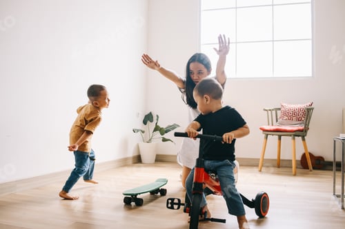 Preview: Family Playing Indoors with Tricycle and Skateboard