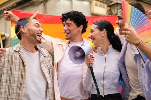 Preview: Diverse young friends celebrating pride with rainbow flag