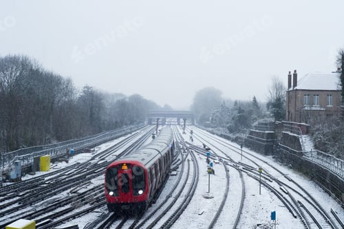 Preview: Red train during winter covered with snow