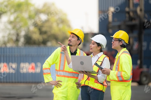 Preview: Group of engineers working with laptop in the container yard.