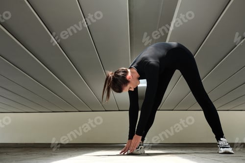 Preview: Woman doing stretching exercises at studio