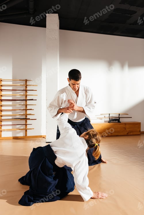 Preview: Martial Arts Sensei Demonstrating Wrist Lock Technique to Female Partner