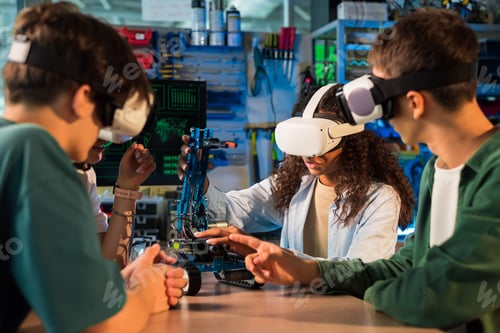 Preview: Group of young people in VR glasses doing experiments in robotics in a laboratory