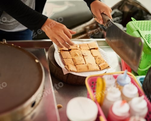 Preview: Fresh and delicious. Shot of an unidentifiable food vendor in Thailand preparing a tasty snack.