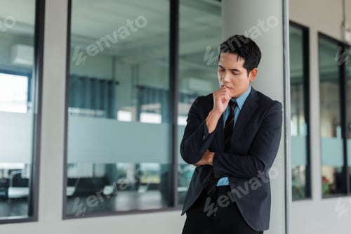 Preview: Asian businessman contemplating solution while thinking