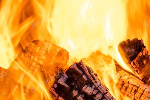 Preview: Close up of brightly burning wooden logs with yellow hot flames of fire at night