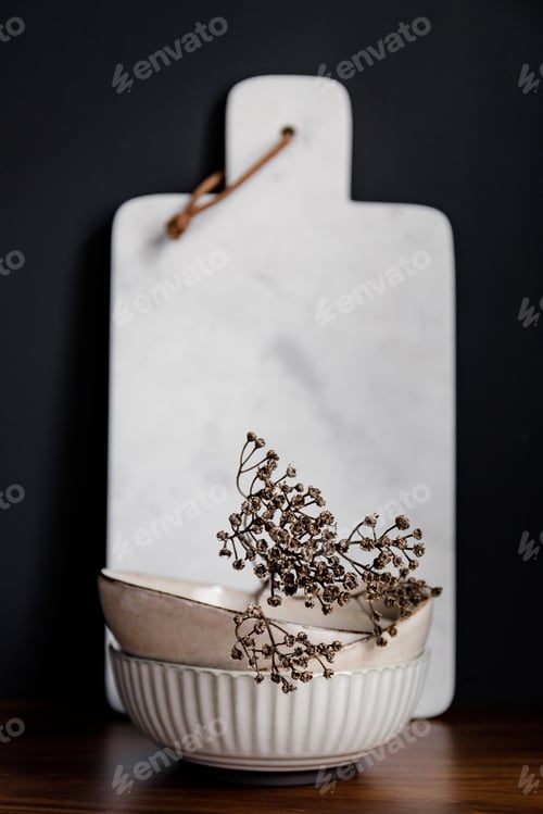 Preview: Set of kitchen ceramic tableware and white marble cutting board on a wooden table.