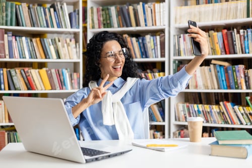 Preview: Hispanic student taking a selfie in the library