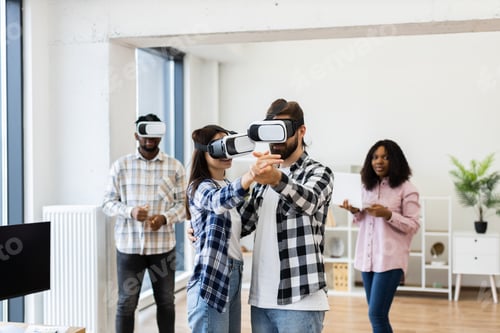 Preview: Group of Colleagues Using Virtual Reality Headsets in Modern Office