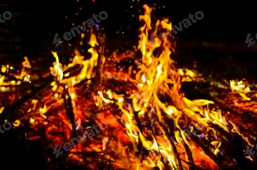 Preview: Blurred out campfire with burning wood