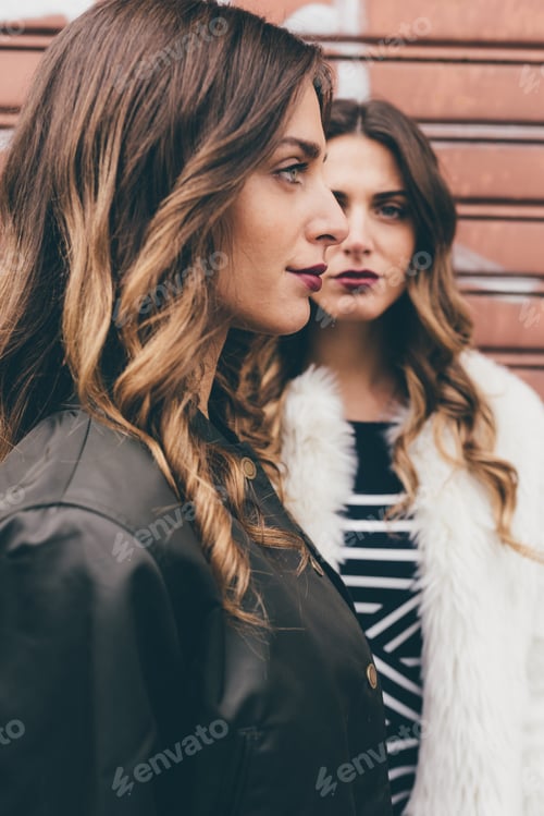 Preview: Portrait of twin sisters in urban area