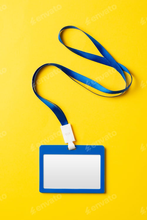 Preview: Blank nametag on a string on yellow background copy space