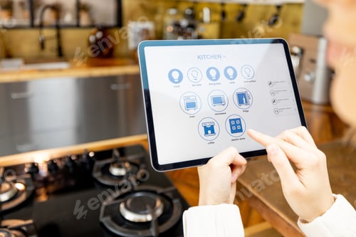 Preview: Woman holding digital tablet with running smart home application in the kitchen