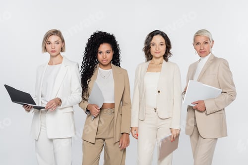 Preview: Interracial businesswomen holding paper folders isolated on grey