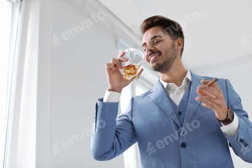 Preview: Man with glass of whiskey and cigar indoors
