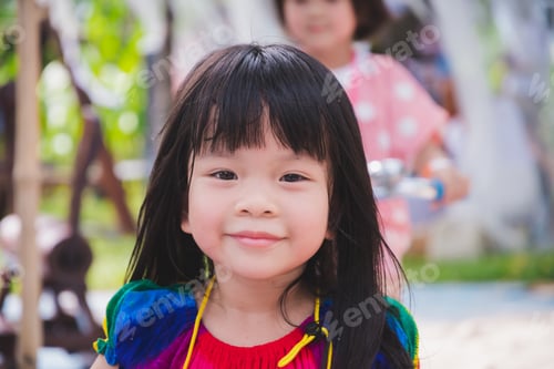 Preview: Adorable Asian girl with sweet smile face. Happy kid are playing in the playground.