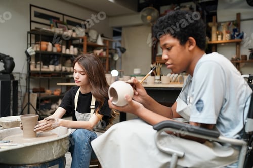Preview: Young Woman hand potter making clay vase in pottery workshop, Business owner.