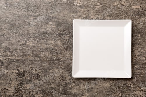 Preview: Top view of empty square plate on cement background. Empty space for your design