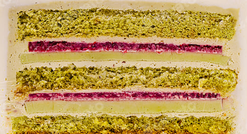 Preview: Colorful dessert layers featuring green and red fillings on a white base