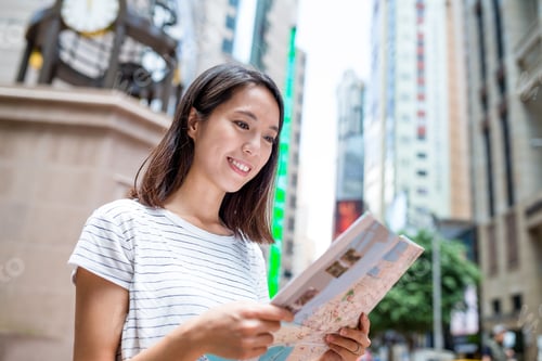 Preview: Woman finding the location on city map in Hong Kong