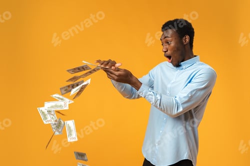 Preview: Excited black guy holding stack of Dollars in yellow studio