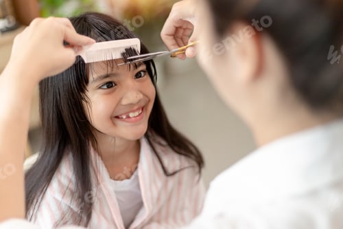 Preview: Smiling Girl Getting a Haircut at Home