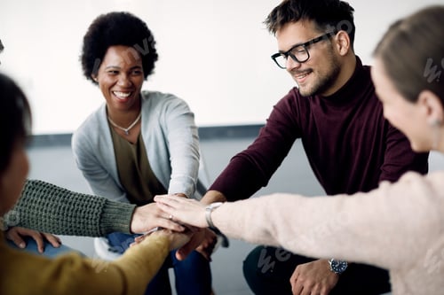 Preview: Attenders of group therapy joining hands in unity during a meeting.