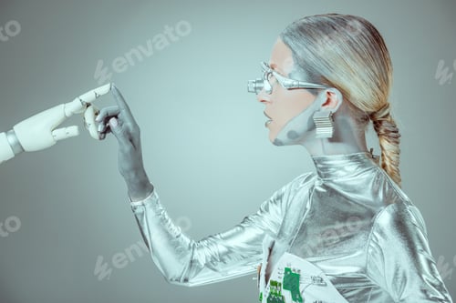 Preview: side view of cyborg touching robotic arm isolated on grey, future technology concept